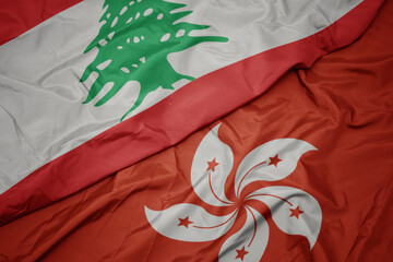 waving colorful flag of hong kong and national flag of lebanon.