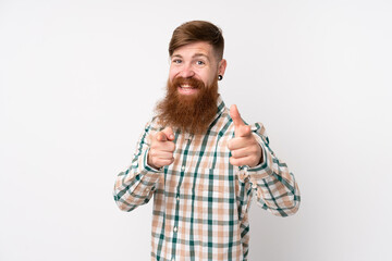 Fototapeta premium Redhead man with long beard over isolated white background pointing to the front and smiling