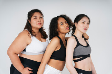 Fototapeta na wymiar Portrait of diverse with asian and african women in wear sport bra outfit on white background.