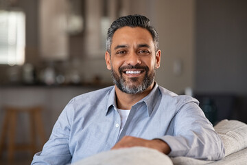 Portrait of happy indian man smiling at home - Powered by Adobe