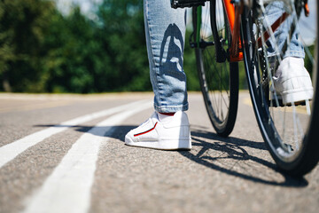 Cycling outdoors, close up of the feet on ground