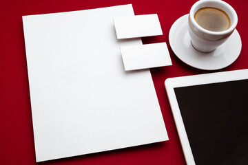 Obraz na płótnie Canvas Coffee, devices, blank flyer posters and cards floating above red background. Office styled, modern mockup for advertising, image or text. Blank white copyspace for design, business and finance