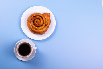 a cup of espresso and cinnamon roll