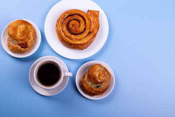a cup of espresso and cinnamon roll