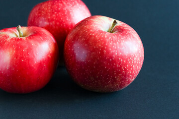 fresh red apples on dark
