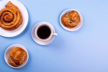 a cup of espresso and cinnamon roll