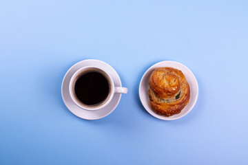 a cup of espresso and cinnamon roll