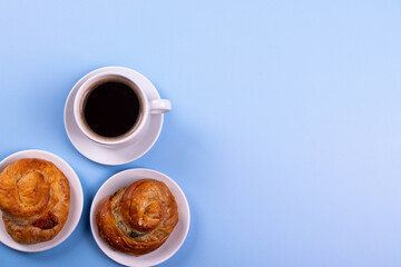 a cup of espresso and cinnamon roll