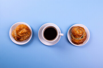 a cup of espresso and cinnamon roll