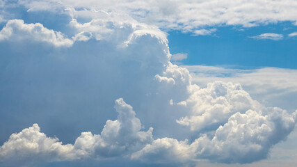 White fluffy big cloud in the sky in sunny weather