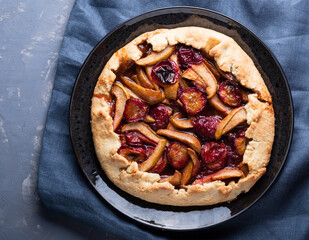 autumn galette with plums and pears. Open cottage cheese dough pie.