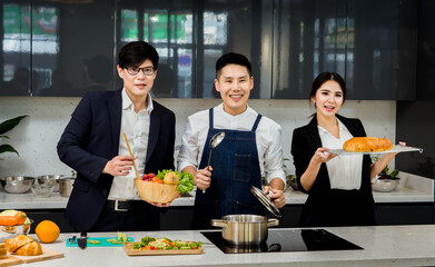 Chef cooking in kitchen.happy of Asian man chef cooking in kitchen.food and healthy concept.