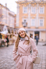 Smiling young beautiful woman in the center of the European Chri