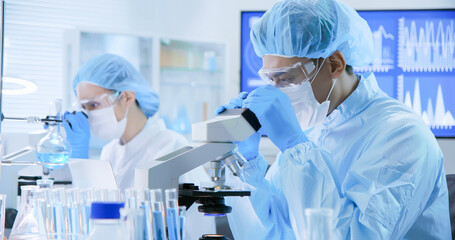 Asian scientist take petri dish