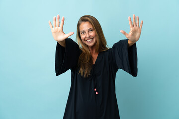 Middle age brazilian woman isolated on blue background counting ten with fingers