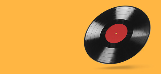 Analog vinyl record isolated on orange background