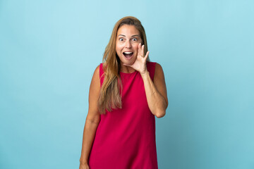 Middle age brazilian woman isolated on blue background with surprise and shocked facial expression