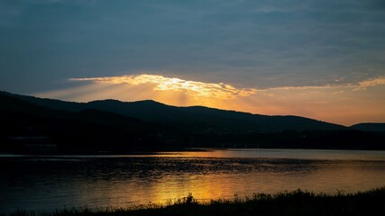 Beautiful golden sunset reflected in lake water. Panorama. Lake Mucharz. Jezioro Mucharskie, Poland