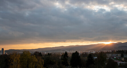 Beautiful autumn sunset with orange sky over Radvan - part of Banska Bystrica, Slovakia. View on office building.