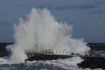 Fototapeta na wymiar Vorupør pier, Water splash about 6 meters high, Cold Hawaii