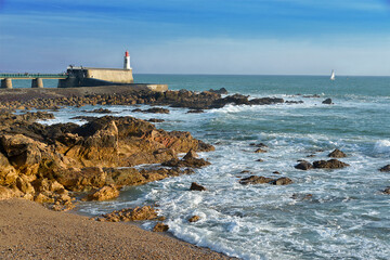 Rocky coastline and lighthouse at Les Sables d'Olonne, commune in the Vendée department in the...