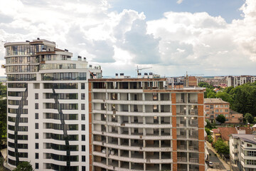 Aerial view of tall residential apartment building under construction. Real estate development.