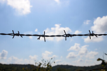 silhouette of wire fences. Sky and clouds