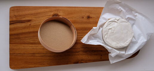 Fototapeta na wymiar cheese with packaging on a board