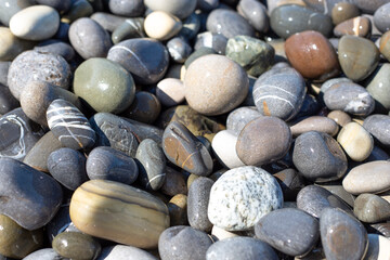 Wet, shiny stones on the shore of the sea, ocean, river or lake