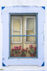 Fototapeta na wymiar window with flowers in Olhao, Algarve, Portugal.