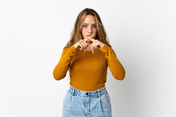Young blonde woman isolated on blue background showing a sign of silence gesture