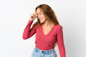 Young blonde woman isolated on blue background laughing