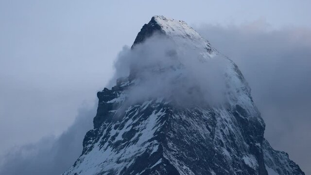 Matterhorn mountain summit with clouds unveiling the peak in real time close-up in Zermatt Switzerland