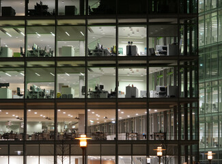 Corporate bussiness financial offices modern glass building lit by night