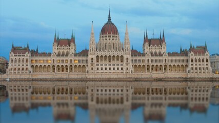 Fototapeta premium Budapest Parliament mirrored in Danube River at evening