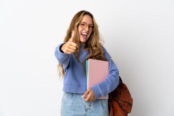 Young student woman isolated on white background with thumbs up because something good has happened