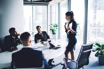 Fototapeta premium Successful leadership explaining monetary gain during together training at conference table, male and female professional colleagues research strategy during productive brainstorming in office