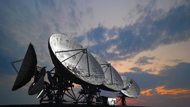 Satellite antennas at sunset, information technology astronomical research