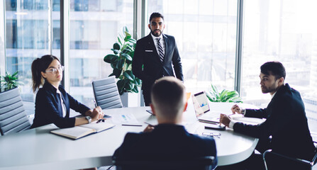 Obraz premium Colleagues listening opinion of boss during meeting in conference room
