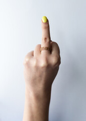 Female hand with extended middle finger