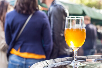 Glasses of light beer on a pub background.