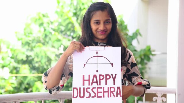 Girl show inscription "HAPPY DUSSEHRA" due to corona virus. Shot in 4k resolution.