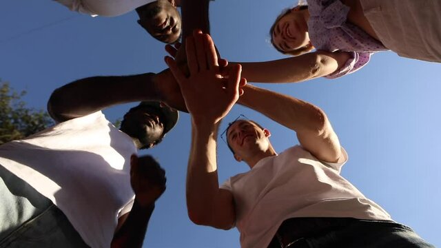 Friends fold their hands. Team and friendship,unity of nations concept