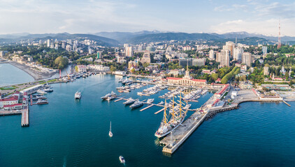 Fototapeta na wymiar Aerial photography. The black sea coast of Russia, the city of Sochi, seaport, yachts and ships at the pier. City attraction