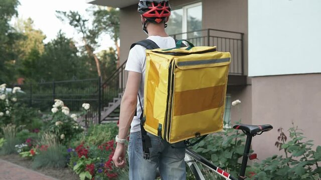 Courier delivery of food by bicycle during an outbreak of the virus. Coronavirus, COVID-19, safe delivery.	
