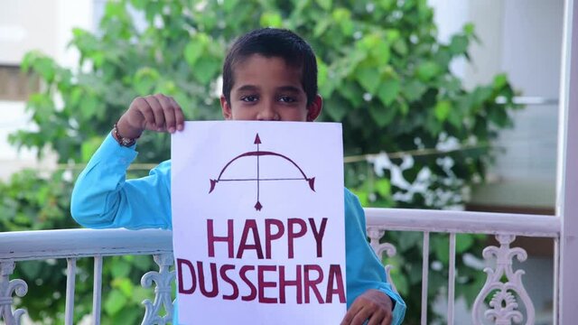 Boy show inscription "HAPPY DUSSEHRA" due to corona virus. Shot in 4k resolution.