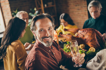 Photo of full family gathering bristled father shiny smiling hold wineglass prepare say warm words about meeting make wish served dinner big table generation home evening living room indoors