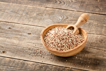 Mixed dry quinoa on wooden table