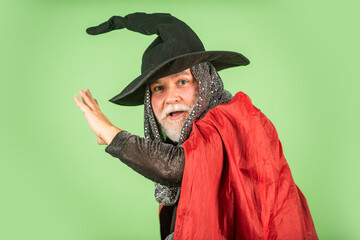 Weird old grandfather with gray beard. Devil man. Holiday and celebration. Magic hat. Best ideas for Halloween. Halloween party. witch man in hat and cloak. happy halloween