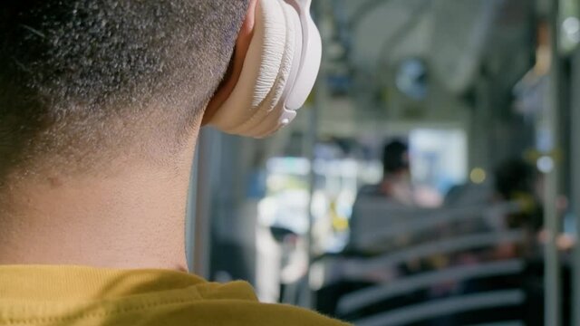 man listening to music on the bus 